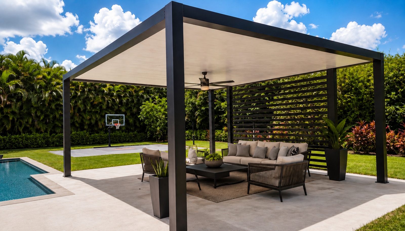 Black aluminum patio cover with a slatted privacy wall over a poolside seating area