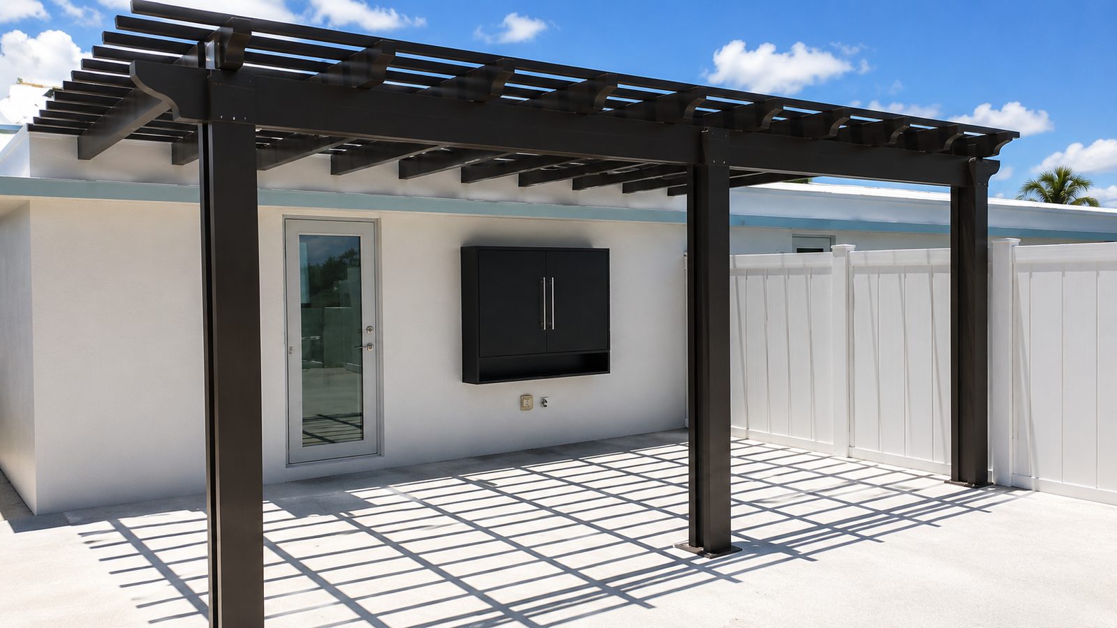 Bronze aluminum open-lattice pergola casting shadows across a white walled terrace