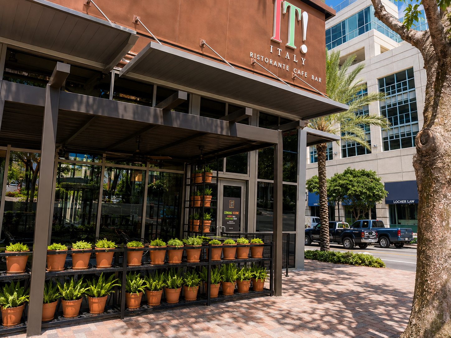 Aluminum canopy and awning over the sidewalk entrance of a downtown restaurant