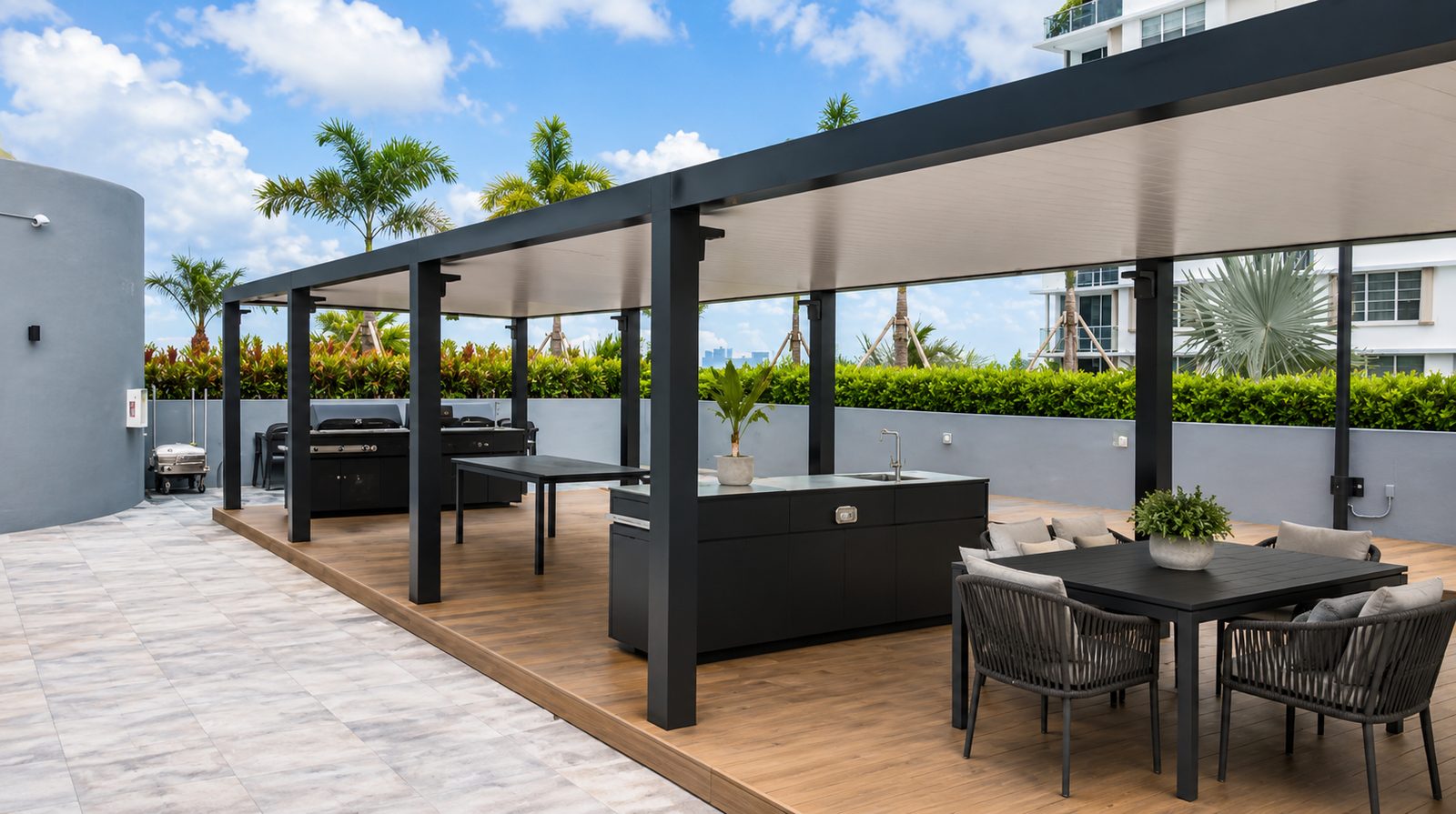 Row of black aluminum covers over grill stations and dining tables on a rooftop terrace